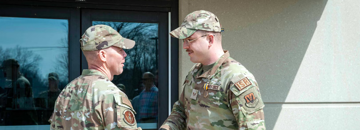 NSWC Crane Employee, Daniel Sweeney, is recognized during in Personnel Force Innovation (PFI) program as an active-duty Air Force airman.